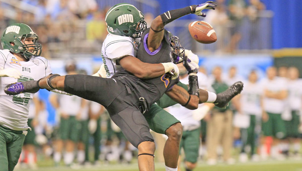 Ohio's Travis Carrie (18), back, breaks up a pass to East Carolina's Justin Hardy (2) during the Beef 'O' Brady's Bowl at Tropicana Field in St. Petersburg, Fla., Monday. (MCT Direct Photo)