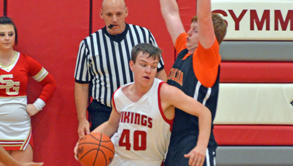 Symmes Valley’s Jacob Klaiber (40) drives for two of his 17 pionts in the Vikings 75-61 win over South Gallia Friday. an orange out in support of Ashley Dennison, our student who is undergoing chemo treatments for kidney cancer. Both teams wore orange socks as well as many fans of both teams in support of Dennison. (Courtesy of Robert S. Stevens of The Gold Studio in Ironton)