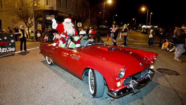 Santa Claus makes his way down South Third Street to the end of the Ironton Christmas Parade Monday evening in downtown Ironton. This year Mike Carey, owner of the Thunderbird, received the Appreciation Award for use of his car that has carried Santa since 1998.