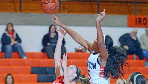 Ironton Lady Fighting Tigers’ Lexie Barrier (right) blocks the shot of Rock Hill’s Kasey Russell (34) during Wednesday’s game. Ironton beat the Redwomen 60-33. (Kent Sanborn of Southern Ohio Sports Photos)