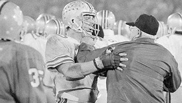 Ohio State guard and former Ironton lineman Ken Fritz (right) holds back head coach Woody Hayes after he hit Clemson linebacker Charlie Bauman in the 1978 Gator Bowl. (Associated Press File Photo)