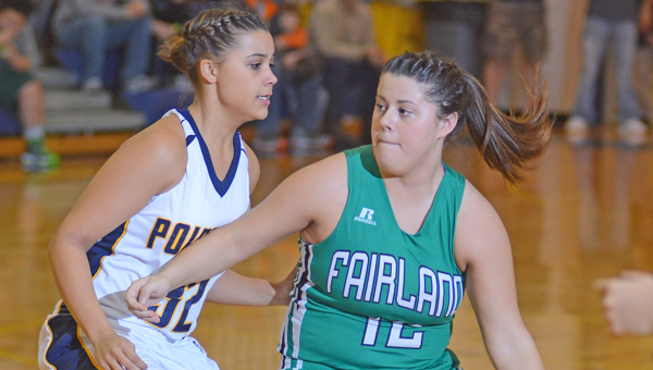 Fairland Lady Dragons’ guard Chandler Fulks (12) drives against South Point Lady Pointers’ Aundrea Bradburn. Fairland won the key OVC game, 64-44. (Kent Sanborn of Southern Ohio Sports Photos)