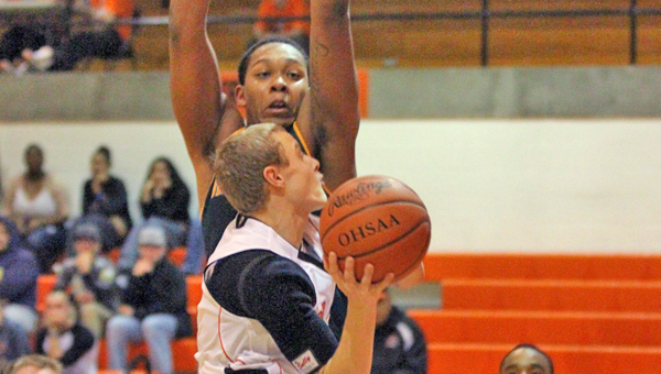 Ironton Fighting Tigers' guard Phillip Kratzenberg drives to the basket and draws a foul during Saturday's game against Huntington High (W.Va.). The Fighting Tigers nealy pulled off a major upset before losing 53-51 to the unbeaten Highlanders. (Courtesy Tim Gearhart of Tim's News & Novelties in Ironton)