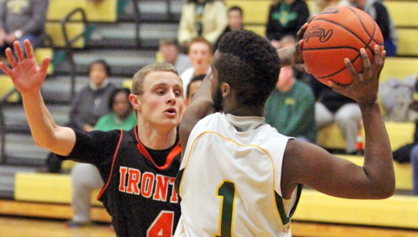 Ironton Fighting Tigers’ Phillip Kratzenberg (4) applies defensive pressure to Greenup County’s Jherrell Jackson (1) during Monday’s game at Lloyd, Ky. The Musketeers managed to beat the Fighting Tigers in overtime, 63-57. (Courtesy Tim Gearhart of Tim’s News & Novelties in Ironton)