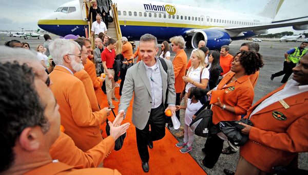 Ohio State football coach Urban Meyer arrives onto the orange carpet as his team arrives at Fort Lauderdale/Hollywood International Airport in Fort Lauderdale, Fla., Sunday. Ohio State will play Clemson in the Orange Bowl Friday night. (MCT Direct Photos)