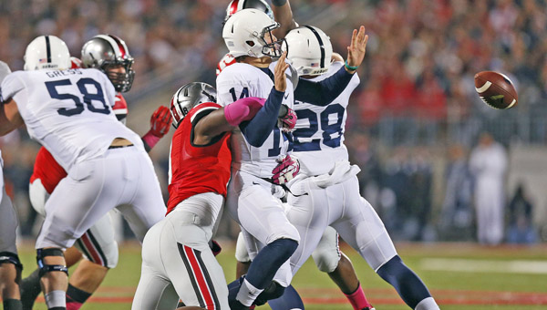 Ohio State Buckeyes’ defensive lineman Noah Spence (8) forces a fumble by Penn State Nittany Lions quarterback Christian Hackenberg (14) during a game earlier this season. Spence was suspended by the Big Ten for testing positive for ecstasy. (MCT Direct Photo)