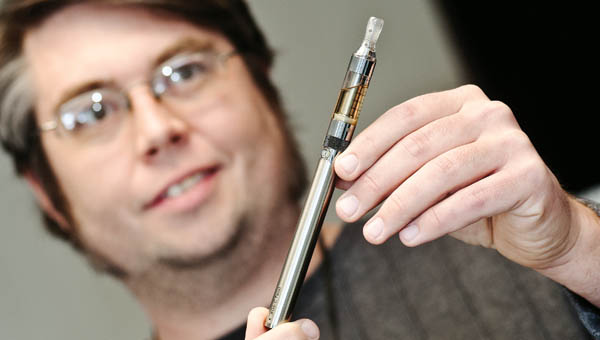 Joe Gehrling shows off his own vaporizer, an electronic cigarette, at his business Vapor Express in Coal Grove.