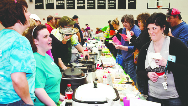 The Tribune/Jessica St. James (ABOVE) Chili aficianadoes test the recipes of cooks participating in the Board of DD chili fest. Month. This year will be the 15th annual festival that brings out cooks from across the Tri-State.