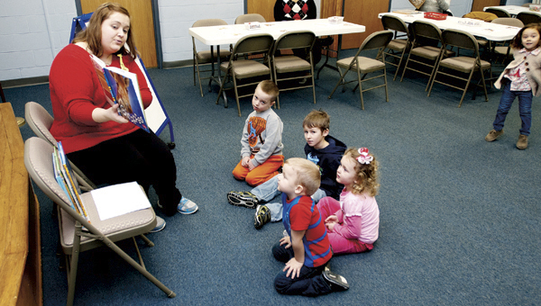 THE TRIBUNE/JUSTIN PRINCE Jane Gullet reads a story about giraffes to a group of preschools at Briggs Library.