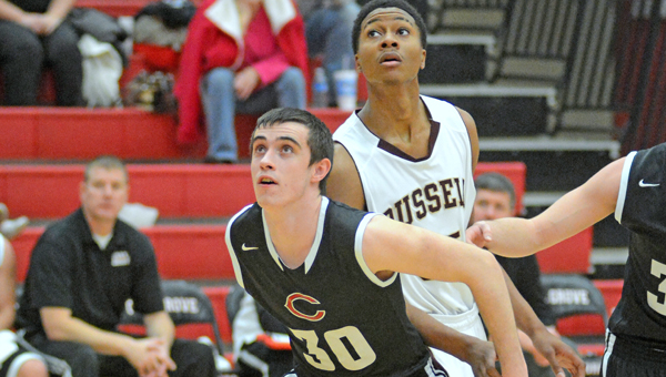 Coal Grove Hornets’ Joe Akers (30) screens a Russell player as he prepares to get a rebound. The Hornets beat Russell 61-43 on Tuesday. (Kent Sanborn of Southern Ohio Sports Photos)