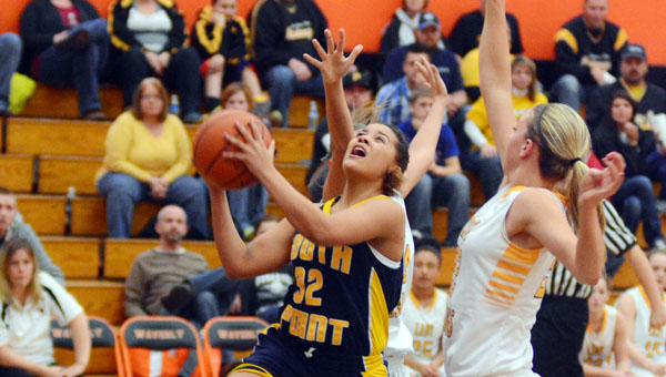 South Point Lady Pointers’ Aundrea Bradburn (32) drives through two Lynchburg Clay defenders as she scores two of her 12 points in a 46-40 comeback win Thursday in the Division III district semifinals. (Kent Sanborn of Southern Ohio Sports Photos)