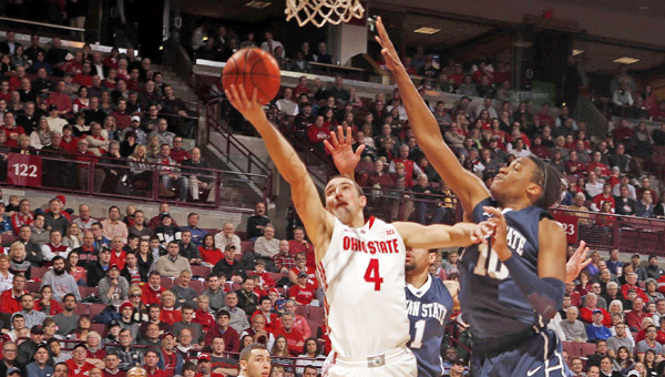 Ohio State’s Aaron Craft (4) puts a shot up against Penn State’s Brandon Taylor (10). Craft and the Buckeyes are trying to find answers to their inconsistent play. (MCT Direct Photos)