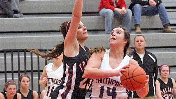 Chesapeake Lady Panthers Kaylee curry (14) drives for two of her 22 points as Coal Grove's Summer Willis defends. Chesapeake beat the Lady Hornets 49-37 Wednesday in the Division III sectional tournament. (Tim Gearhart of Tim's News & Novelties in Ironton)