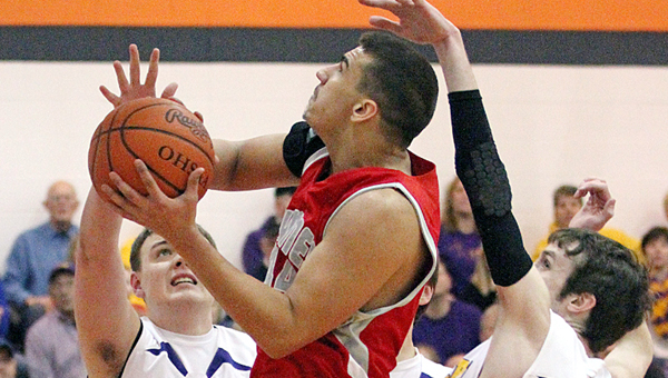 Symmes Valley’s Tyler Rowe attempts to score inside as St. Joseph’s Trey Young (34) and Troy Scott 921) attempt to block the shot. The Vikings won 68-=67 in overtime on Saturday. (Tim Gearhart of Tim’s News & Novelties in Ironton)