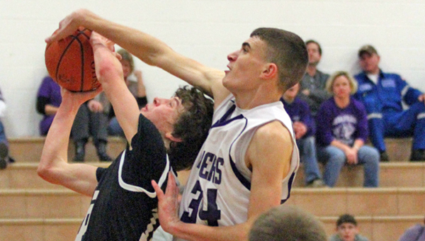Coal Grove Hornets’ Brandon Adkins (left) draws a foul with 1.4 seconds to play and the score tied against the Chesapeake Panthers on Wednesday. Chesapeake’s Andrew Saunders (right) was called for the foul and Adkins hit the second of two free throws to give Coal Grove a 38-37 win. (Courtesy Tim Gearhart of Tim’s News & Novelties in Ironton)