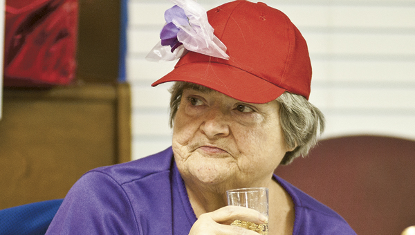 THE TRIBUNE/JESSICA ST JAMES Connie Murphy enjoys a goblet of sparkling cider during a special Red Hat Ladies and Men’s Club Candlelight Dinner at Jo-Lin Health Center in Ironton