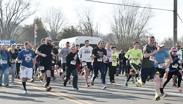 THE TRIBUNE/JESSICA ST JAMES Participants take off from the start line Saturday morning as make their way into The Point Industrial Park during the Board of DD 5k Run Walk event.
