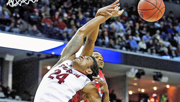 Dayton Flyers' Vee Sanford, middle, and Jordan Sibert, right, grabs a rebound away from Stanford Cardinal's Josh Huestis, left, during first-half action in the NCAA Tournament's Sweet 16 game at FedExForum in Memphis, Tenn., on Thursday. Dayton won 82-72. (MCT Direct Photo)