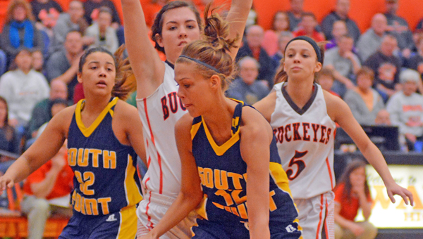South Point Lady Pointers’ senior center Brett Justice tries to drive past a Nelsonville-York defender during Saturday’s Div. III district title game. The Lady Pointers lost 43-26. (Kent Sanborn of Southern Ohio Sports Photos)