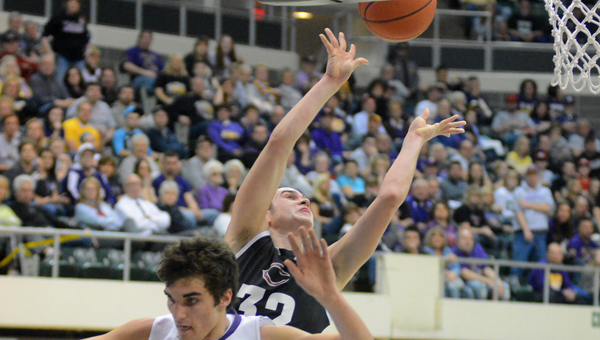 Coal Grove Hornets’ Conor Markins scores as he goes over Lucasville Valley’s Bryan Rolfe (11) during Saturday’s Division III district semifinal game. The Hornets lost 66-65. (Kent Sanborn of Southern Ohio Sports Photos)