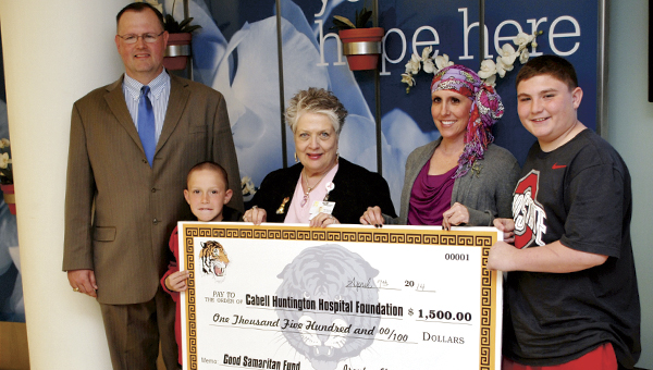 Ironton Principal John Maynard joins Holden Topping and Holden’s mother, Stephanie Rodgers as they present a check to the Cabell Huntington Hospital Foundation.