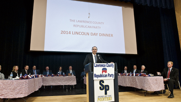 THE TRIBUNE/JESSICA ST JAMES Joe Freeman and eventgoers sitting around him react to speakers on stage during the annual Lincoln Day Dinner Tuesday.