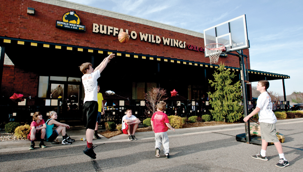 Area children make free throw shots during a promotional Gus Macker event at Buffalo Wild Wings Thursday.