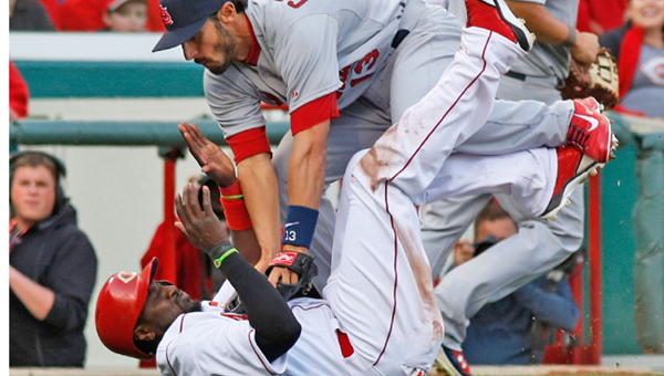 Cincinnati Reds’ Brandon Phillips is tagged out by St. Louis’ Matt Carpenter during a rundown in the eighth inning Monday. The Cardinals blanked the Reds 1-0 on Opening Day. (Photo Courtesy of The Cincinnati Reds)