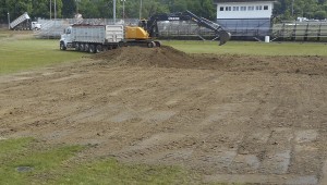 the tribune/brandon roberts Workers from Maryland-based artificial turf company Pro Grass on Tuesday began scraping up the grass on Bob Lutz Field at Tanks Memorial Stadium in Ironton. Once all the grass is up the company will install artificial turf. The project’s completion is expected before Ironton’s first football game on Aug. 30 against Ashland, Ky.