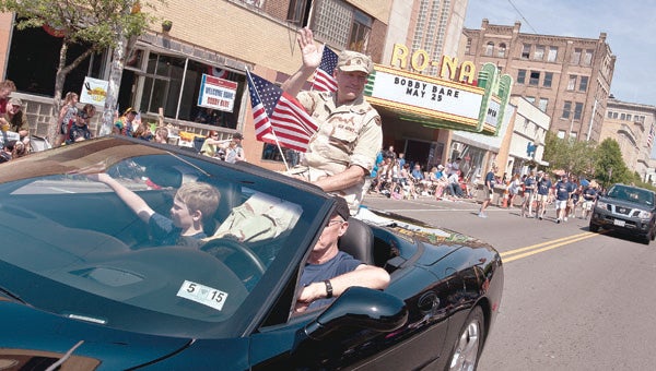 THE TRIBUNE/JESSICA ST JAMES A serviceman with the U.S. Army waves to the crowd during the Ironton-Lawrence County Memorial Day Parade Monday.