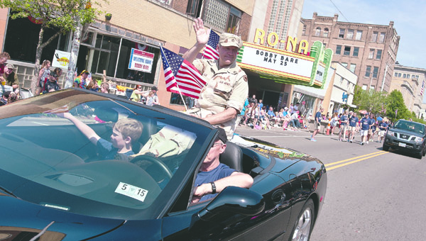 THE TRIBUNE/JESSICA ST JAMES A serviceman with the U.S. Army waves to the crowd during the Ironton-Lawrence County Memorial Day Parade Monday.