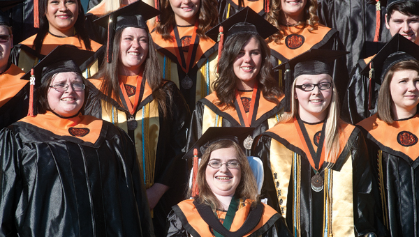 2014 graduate students from Ironton High School gather on the campus’ from steps for the annual class photo before the start of commencement ceremonies Sunday evening.