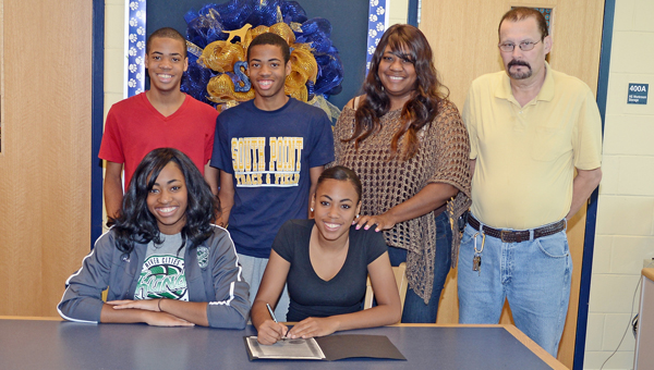South Point Lady Pointers’ senior volleyball standout Tia Pettigrew signed a letter-of-intent to play at University of Northwester Ohio. Attending the ceremony were: seated from left to right, sister Tyra Pettigrew and Tia; standing from left to right, brothers Trey Patterson and Trent Patterson, Pettigrew, mother Melanee Keys and step-father Randy Hagans. (Kent Sanborn of Southern Ohio Sports Photos)