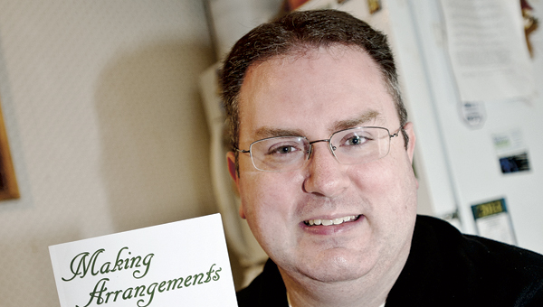 THE TRIBUNE/ Jessica St. James Chesapeake resident Eliot Parker displaying his latest book “Making Arrangements.”