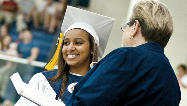 ) Miranda Clair-Kay Lenease Lewis receives her diploma during commencement ceremonies Sunday at South Point High School. (BELOW) Austin Shaffer talks with friends at South Point High School Sunday afternoon.