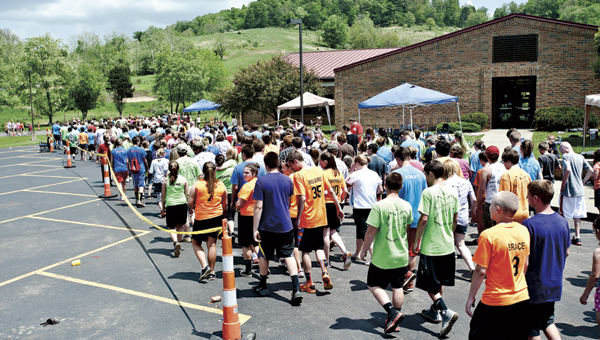 Symmes Valley students join their friends and loved ones during the Survivors Lap at Relay for Life Tuesday.