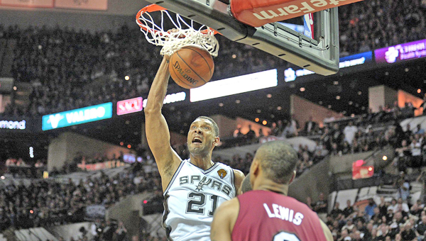 The San Antonio Spurs’ Tim Duncan scores in front of the Miami Heat’s Rashard Lewis (9) during Game 1 of the NBA Finals on Thursday. Duncan had 21 points and 10 rebounds in a 110-95 win. (MCT DIRECT PHOTO)