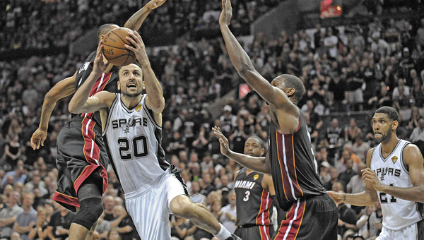 San Antonio Spurs guard Manu Ginobili drives past Miami Heat's Rashard Lewis and Chris Bosh during the first half in Game 5 of the NBA Finals at the AT&T Center in San Antonio, Texas, on Sunday.The Spurs won 104-87 to win their fifth NBC title. (MCT Direct Photo)