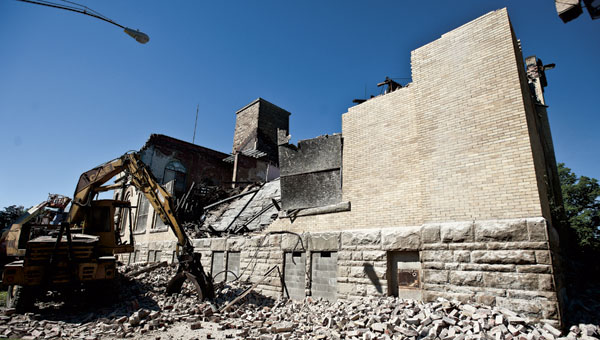 THE TRIBUNE/JESSICA ST JAMES Bricks are scattered around Memorial Hall as crews have begun the demolition of the old building.