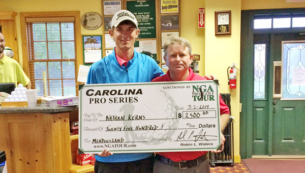 Ironton’s Nathan Kerns (left) proudly displays a replica of the first-place check he was presented after recording his first career professional victory Thursday in the NGA Tour. Kerns won the Meadowlands Tournament in the Carolina Series by two strokes with a nine-under par score. (Photo Submitted)