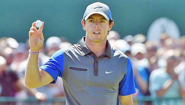 Rory McIlroy walks off the 18th green following his first round 66 that left him as the leader of the British Open on Thursday. (Courtesy PGA.com)