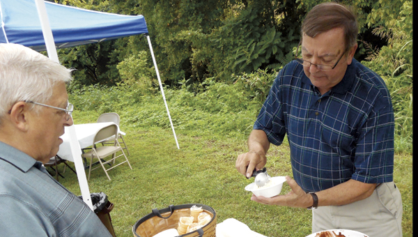 the tribune/brandon roberts Rodney Young serves ice cream to Chesapeake Mayor Dick Gilpin on Tuesday during an ice cream social and Reception welcoming new Ohio University Southern Dean Dr. Nicole Pennington at the Lawrence County Chamber of Commerce.