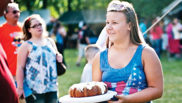Morgan Harper models the sweets at the Cake and Pie Auction at Family Fun Days on Thursday.