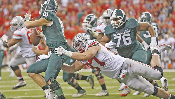 Ohio State defensive end Joey Bosa (97) chases down Michigan State quarterback Connor Cook in last year’s Big Ten championship game. Bosa is one of the key players when the Buckeyes host Virginia Tech on Saturday night in their home opener. (MCT Direct Photos)