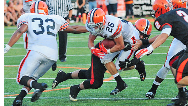 Ironton Fighting Tigers’ running back Tanner Price (26) fights through a Wheelersburg defender during last week’s game. Price ran for 45 yards on just five carries. Ironton plays at Russell on Friday. (Tony Shotsky of Southern Ohio Sports Photos)