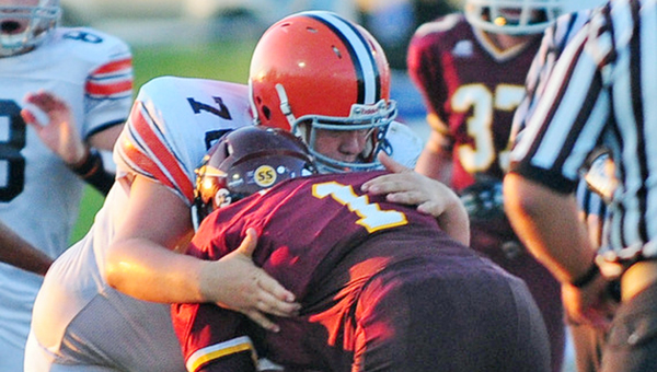 Ironton defensive lineman Hayden Robinson (76) wraps up Russell’s Evan Ison for a mere 1-yard gain during Friday’s game. The Fighting Tigers whipped Russell 36-9. (Tony Shotsky of Southern Ohio Sports Photos)