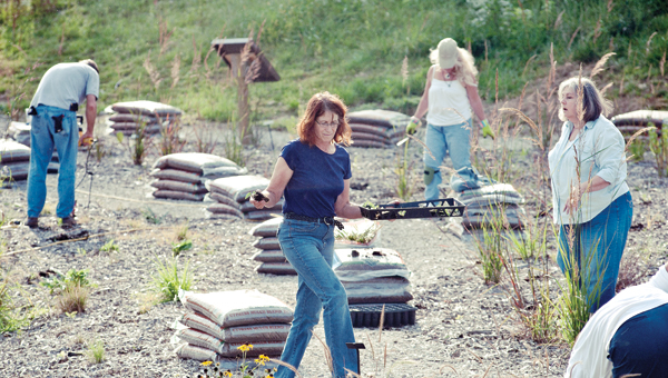 Lorraine Miller, center, is one of many volunteers working on the native plant garden located at the St. Mary’s Medical Center Ironton Campus.
