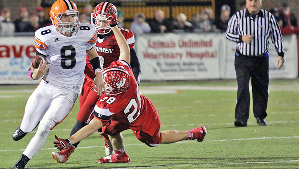 Ironton FIghting Tigers’ senior quarterback Tristan Cox (8) outruns Jackson defender Raymond Potter (28) as he scrambles for a big gain during Friday’s game. Ironton stayed close before falling to unbeaten and No. 8-ranked Jackson 33-21. (Photo Courtesy of Tim Gearhart of Tim’s News & Novelties of Ironton)