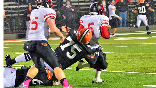Ironton Fighting Tigers’ defensive tackle Isaac Sherman (75) pulls down St. Charles’ running back NiQuille Bell (5) from behind during Friday’s game. Ironton won 25-24. (Tony Shotsky of Southern Ohio Sports Photos)