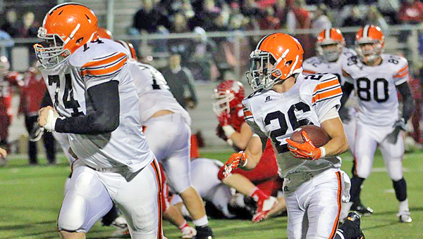 Ironton Fighting Tigers’ guard Tyler Webb (74) leads running back Tanner Price (26) on a sweep during last Friday’s game at unbeaten Jackson. Ironton will host the Raceland Rams at 7:30 p.m. Friday on Senior Night. (Photo Courtesy of Tim Gearhart of Tim’s News & Novelties of Ironton)